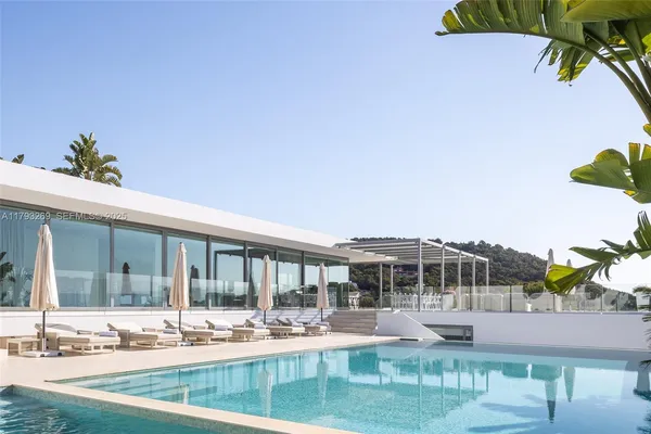 a view of a swimming pool with an outdoor seating and a yard
