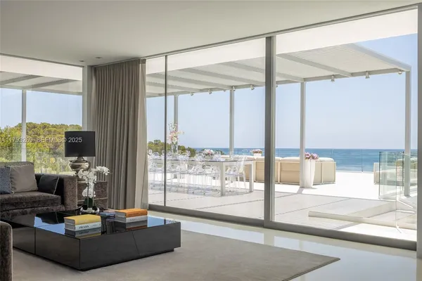 a living room with furniture a large window and a fountain