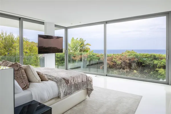 a bathroom with a granite countertop sink a mirror and a shower