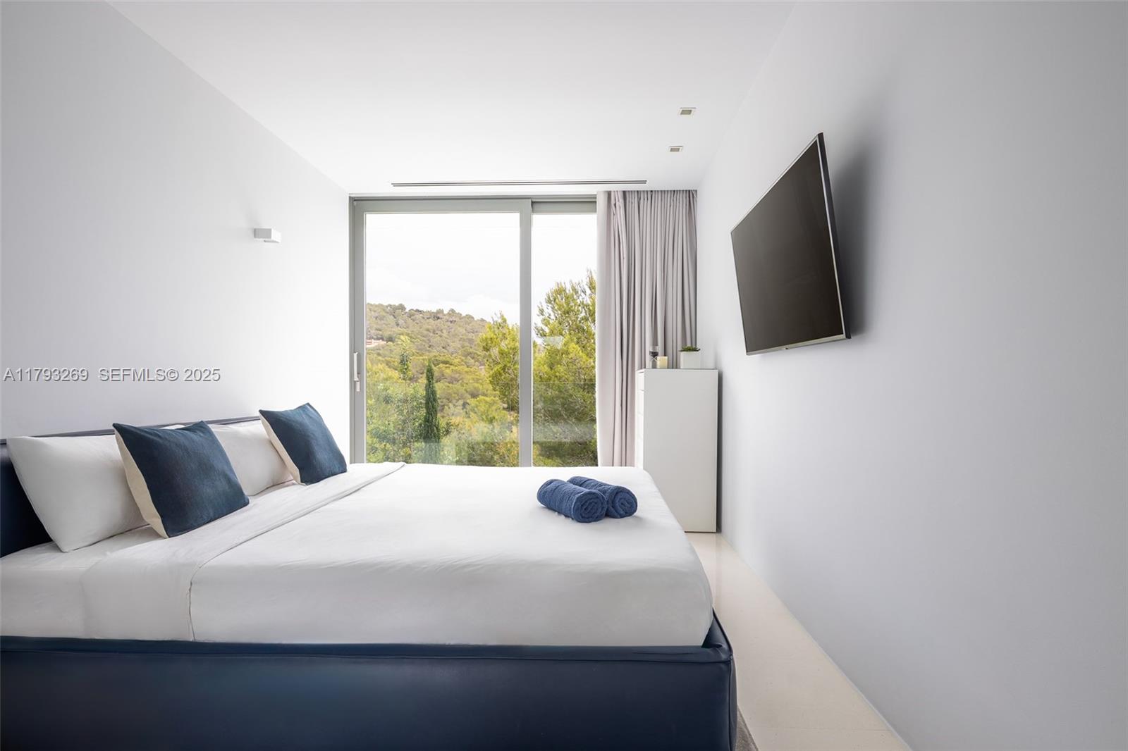 North Cathedral City undefined, FL 00000 - Photo 44 of 70 a bedroom with a bed and a flat tv screen next to a window