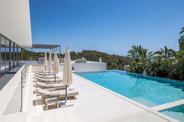 a view of a swimming pool with outdoor seating
