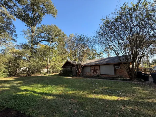 a view of house with backyard