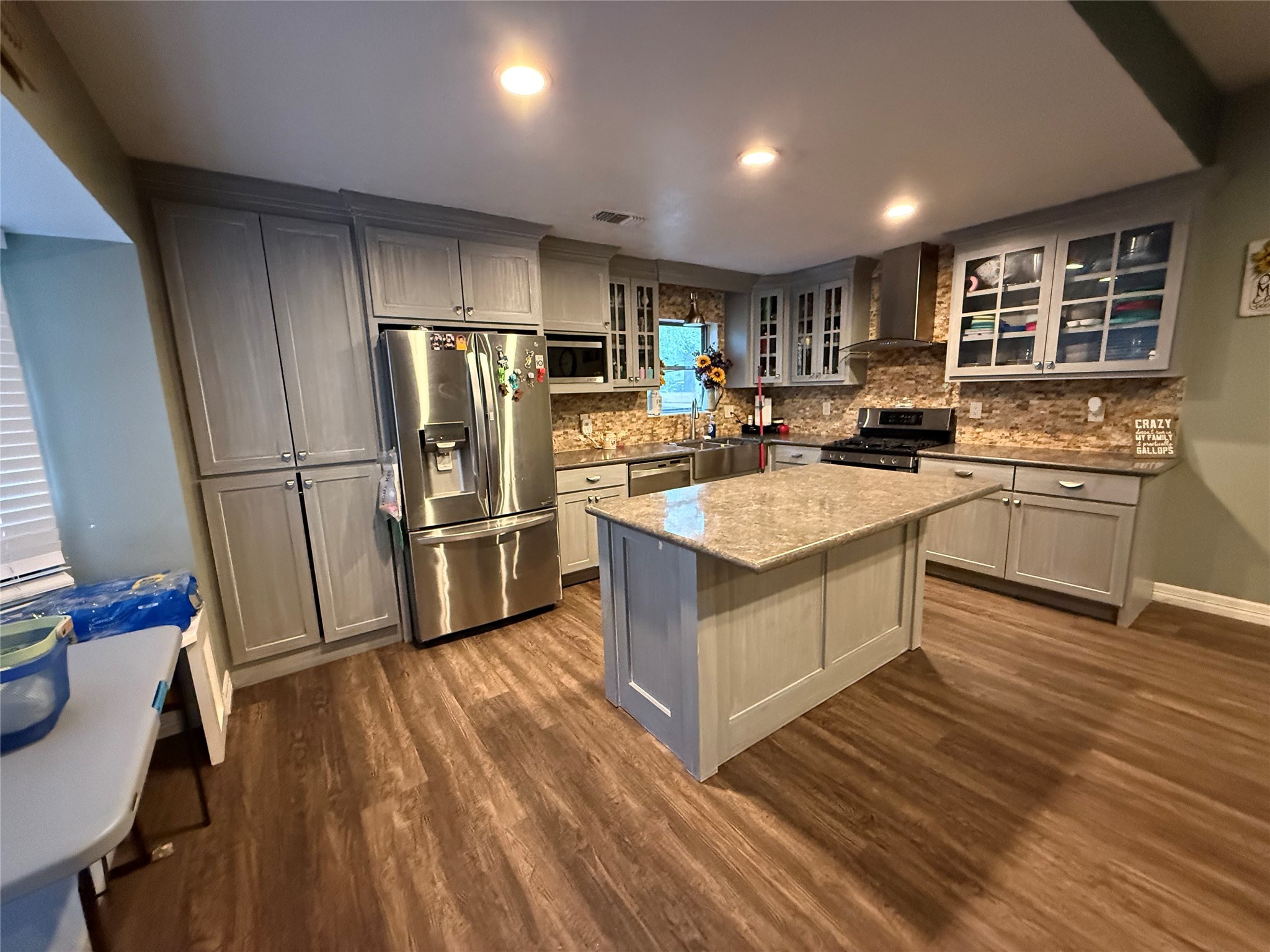 29014 Geneva Drive Spring, TX 77386 - Photo 5 of 14 a large kitchen with a center island wooden floor and stainless steel appliances