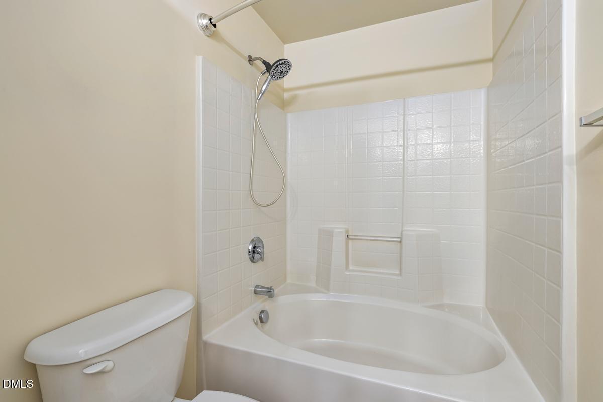 1619 Snow Mass Way Durham, NC 27713 - Photo 11 of 16 a white bath tub sitting next to a toilet