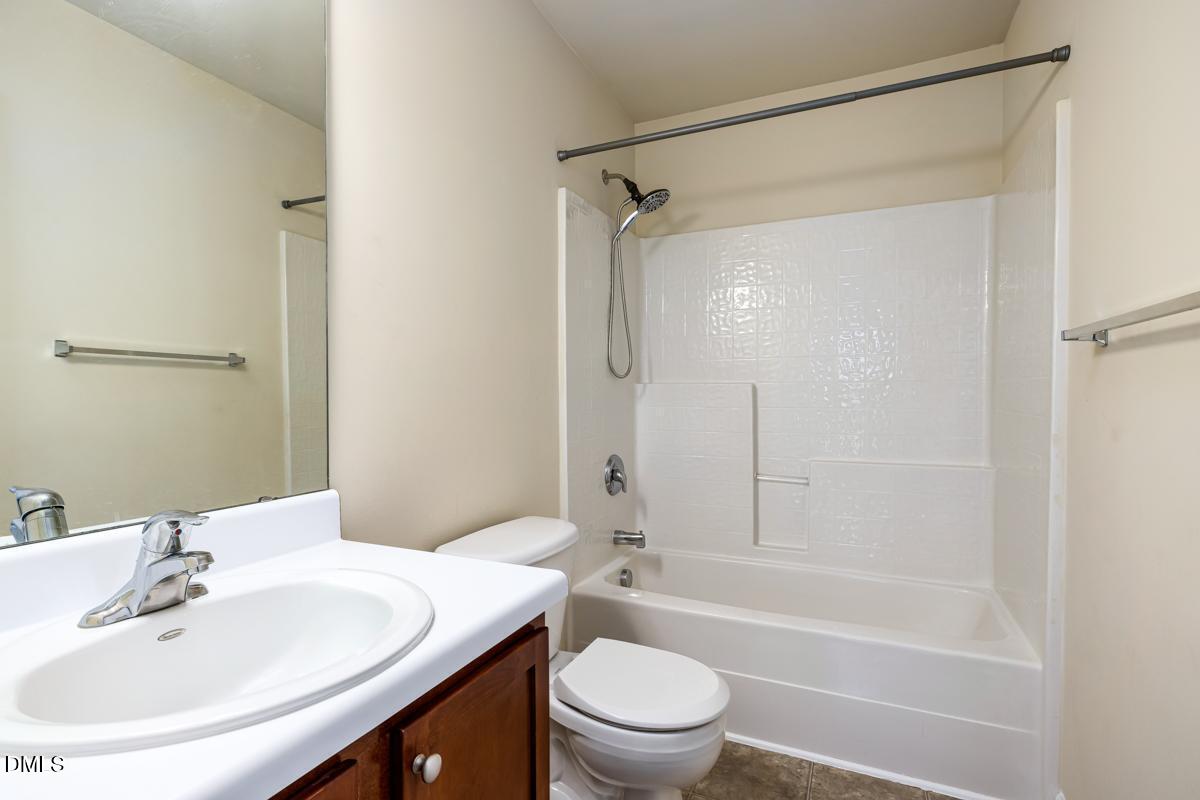 1619 Snow Mass Way Durham, NC 27713 - Photo 15 of 16 a bathroom with a sink a toilet and shower