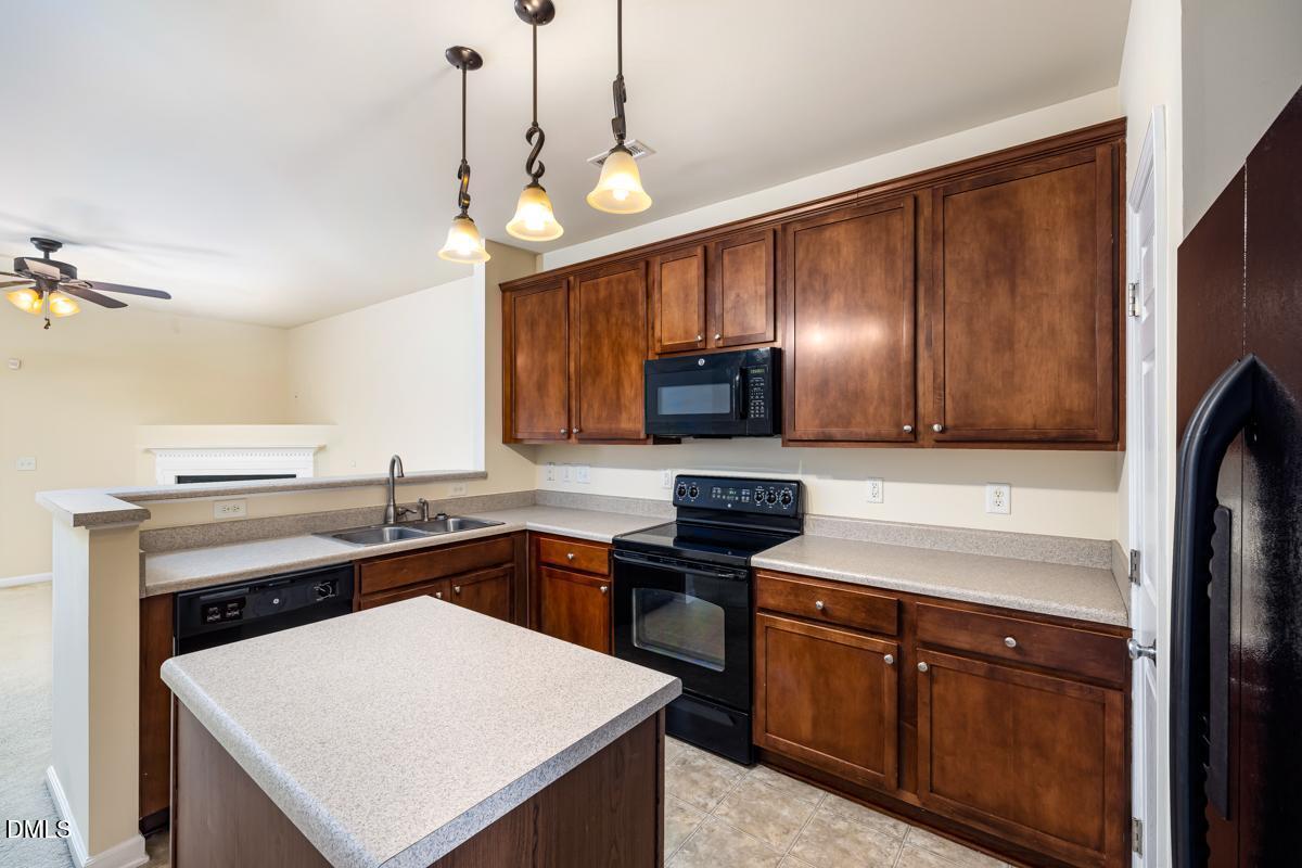 1619 Snow Mass Way Durham, NC 27713 - Photo 4 of 16 a kitchen with stainless steel appliances a sink stove and refrigerator