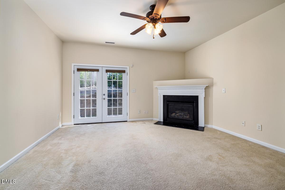 1619 Snow Mass Way Durham, NC 27713 - Photo 7 of 16 a view of an empty room with a fireplace and a window
