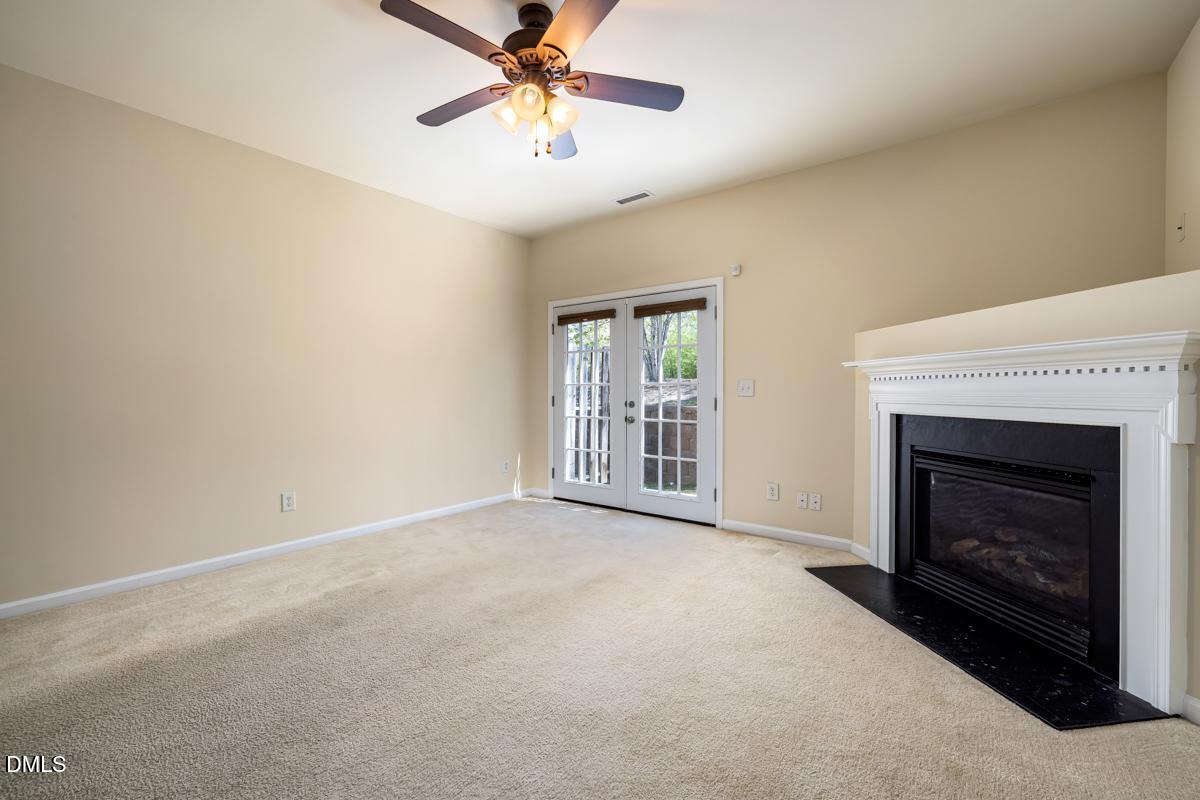 1619 Snow Mass Way Durham, NC 27713 - Photo 9 of 16 a view of an empty room with window and fireplace