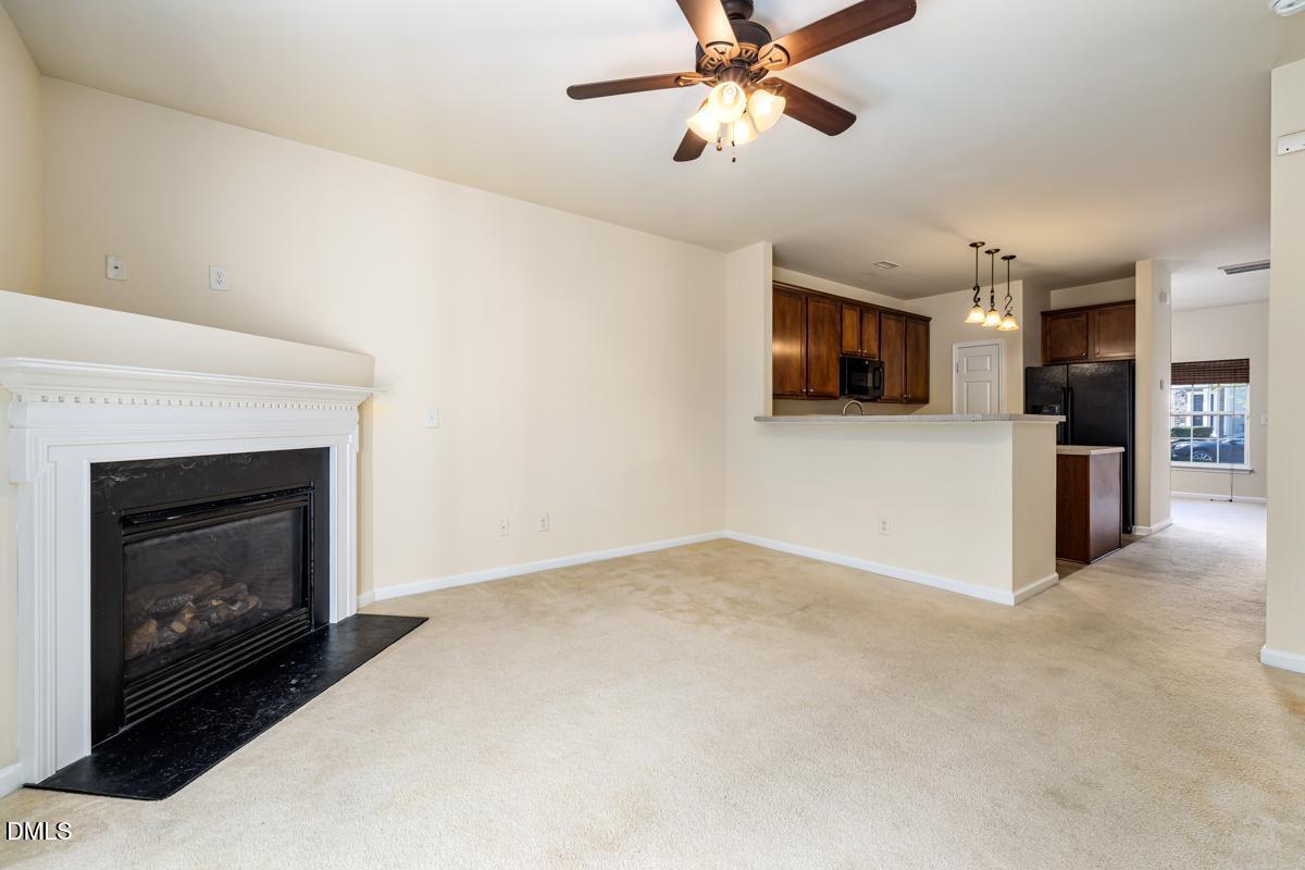 1619 Snow Mass Way Durham, NC 27713 - Photo 10 of 16 a view of a livingroom with a ceiling fan a fireplace and a window