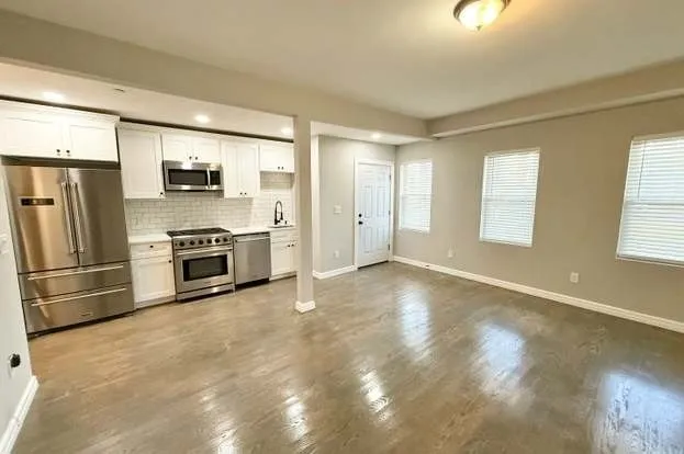 a view of a kitchen with a stove cabinets and a refrigerator