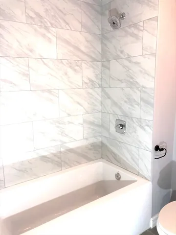 a bath tub sitting next to a white toilet