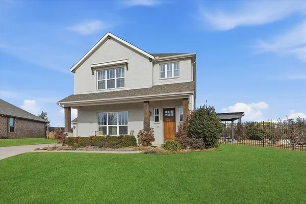 a front view of house with yard and green space