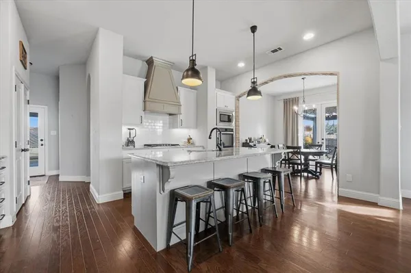 a large kitchen with a table and chairs