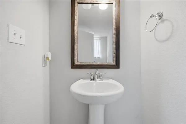 a bathroom with a sink and mirror