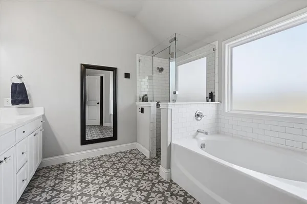 a bathroom with a bathtub and a shower