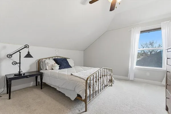 a bedroom with a bed and large window