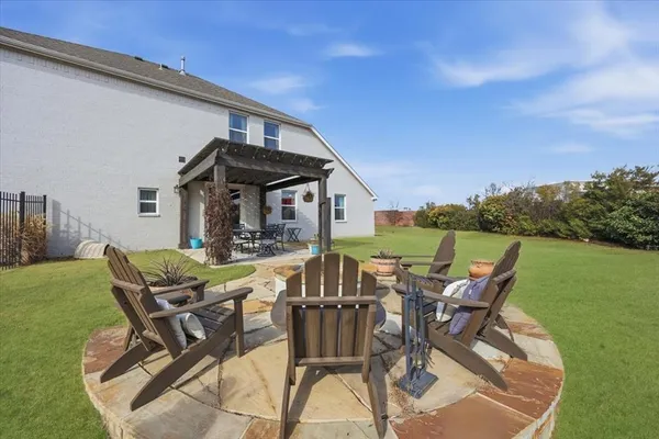 a view of a patio with table and chairs with wooden floor and fence