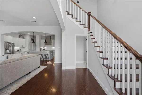 a view of entryway and hall with wooden floor