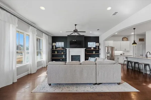 a living room with fireplace furniture and a wooden floor