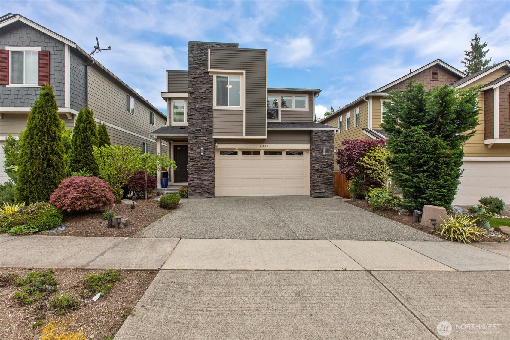 18231 3rd Drive Southeast Bothell, WA 98012 - Photo 1 of 40 a front view of a house with a yard and a garage