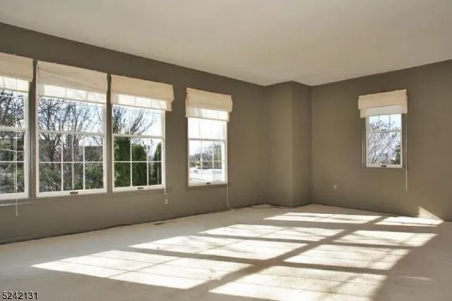 a view of a bedroom with wooden floor and a window