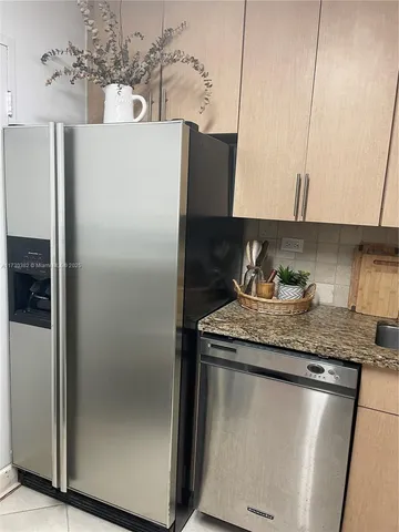 a white refrigerator freezer sitting inside of a kitchen