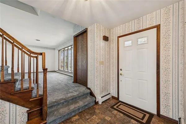 a bedroom with a large bed couch and a window