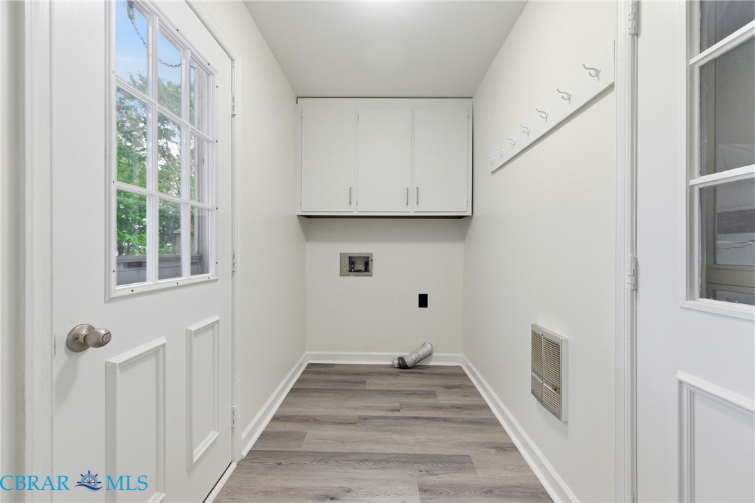 718 Dandy Loop Road Yorktown, VA 23692 - Photo 24 of 42 Laundry area featuring light wood-type flooring, cabinet space, and washer hookup