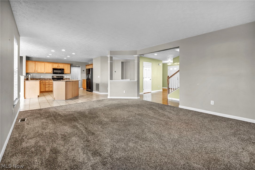 147 Stone Ridge Way Berea, OH 44017 - Photo 7 of 44 Unfurnished living room featuring light carpet, recessed lighting, and a textured ceiling