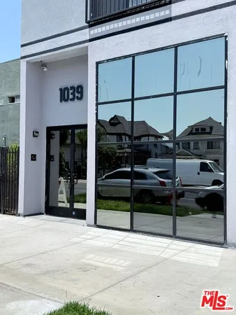 a kitchen with a wooden floor and white appliances