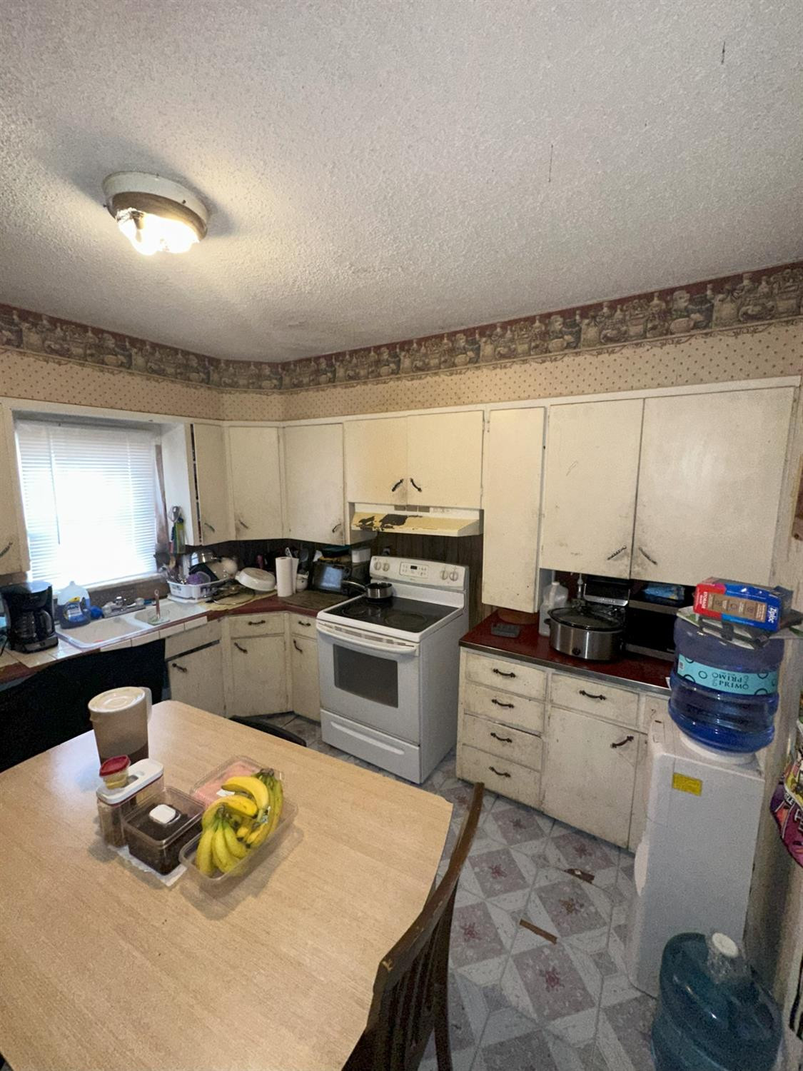 115 Yonkers Street Plainview, TX 79072 - Photo 11 of 20 a kitchen with a stove a sink and a refrigerator