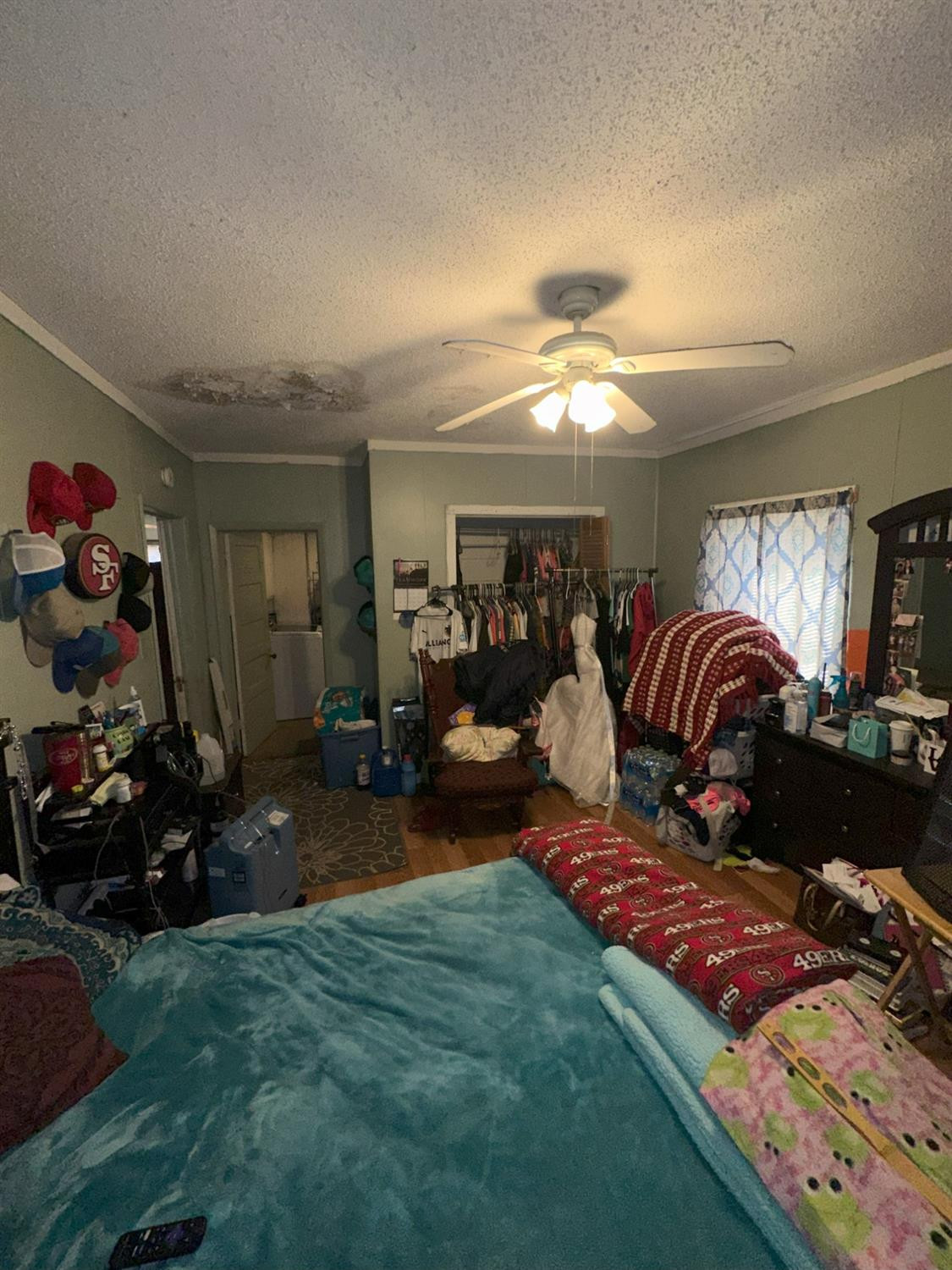 115 Yonkers Street Plainview, TX 79072 - Photo 15 of 20 a bedroom with bed and a chandelier