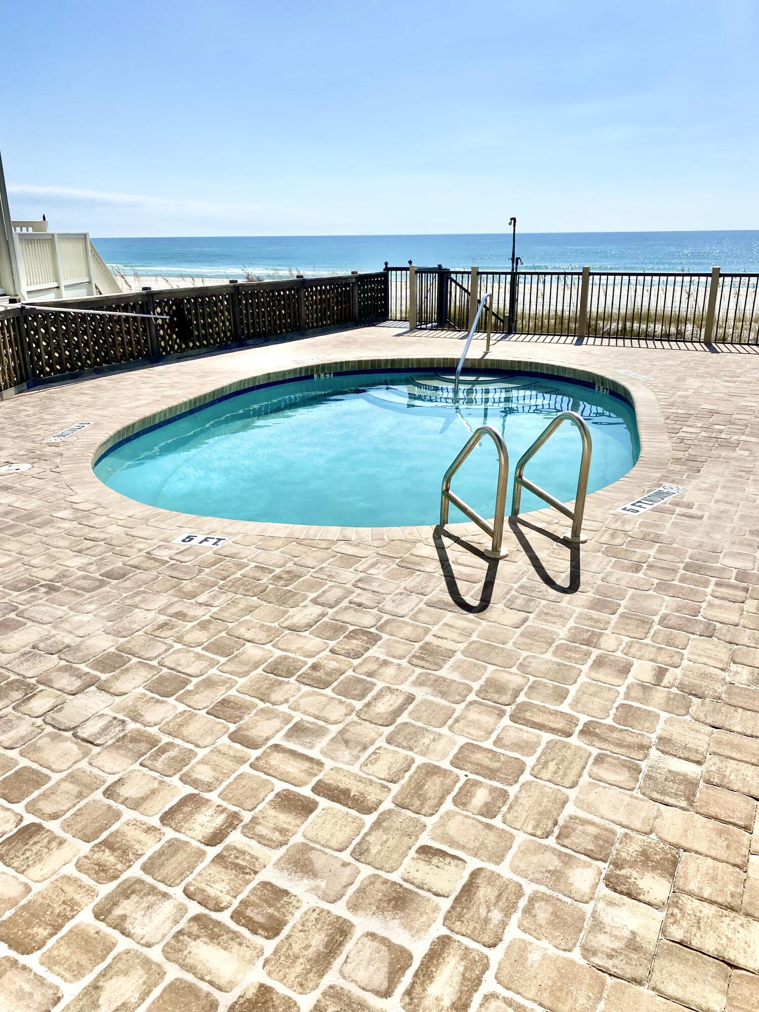 17657 Front Beach Road, Unit B Panama City Beach, FL 32413 - Photo 11 of 34 a view of swimming pool with outdoor seating and a yard