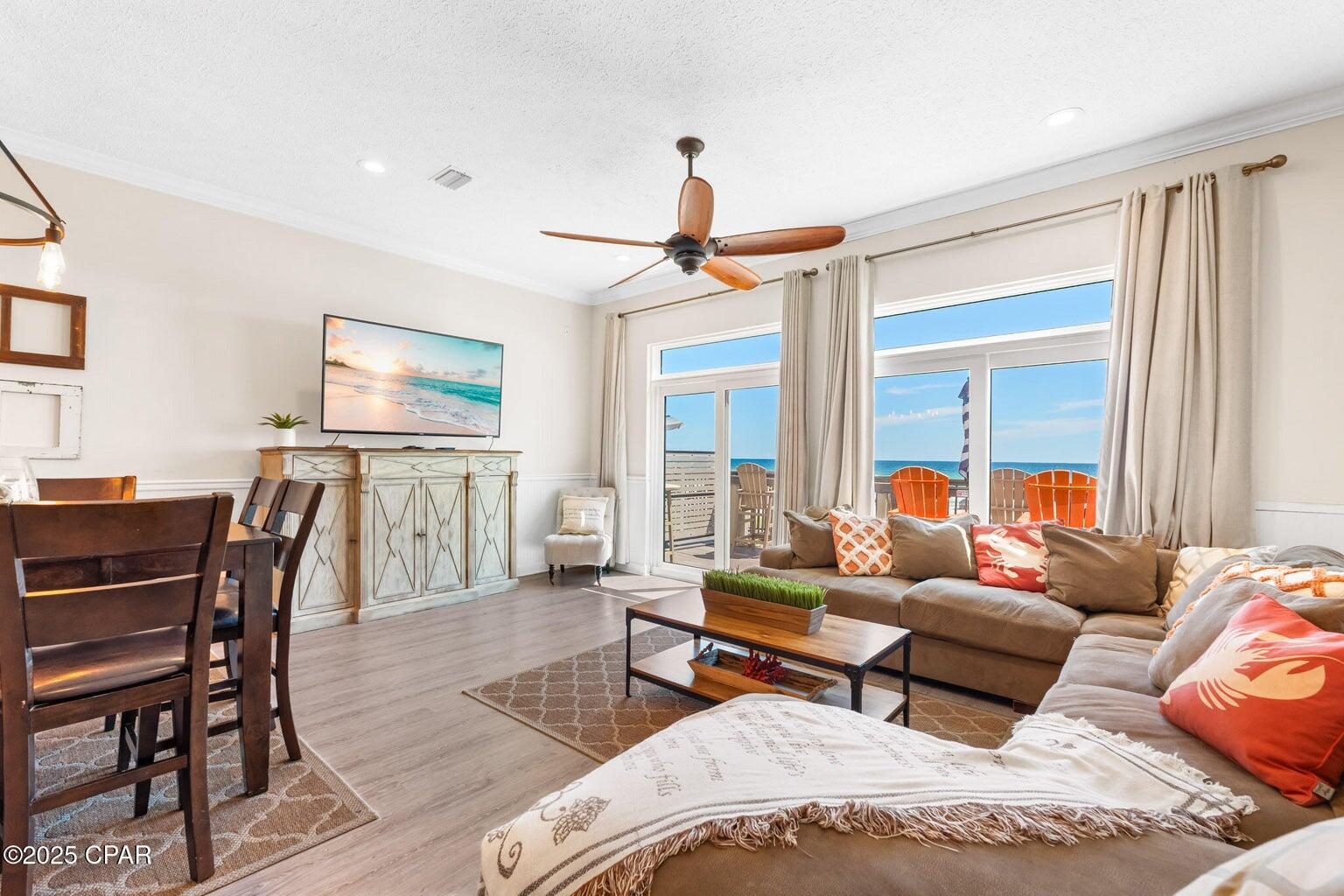 17657 Front Beach Road, Unit B Panama City Beach, FL 32413 - Photo 12 of 34 a living room with furniture and a flat screen tv