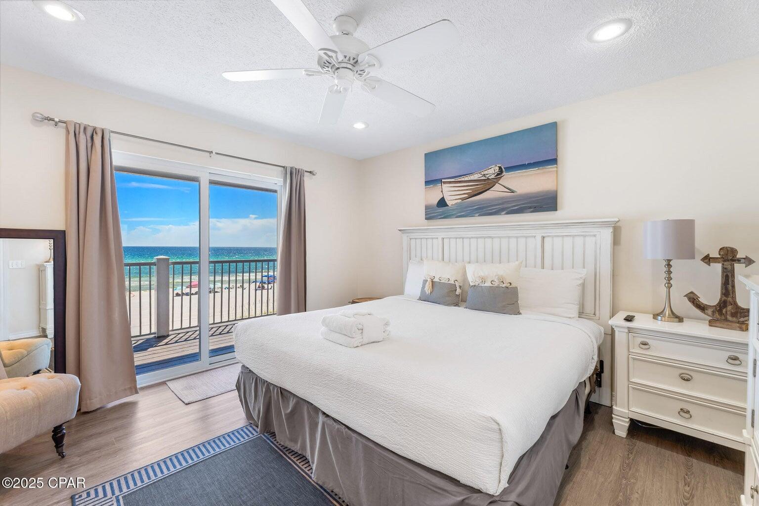 17657 Front Beach Road, Unit B Panama City Beach, FL 32413 - Photo 14 of 34 a bedroom with a large bed and a window