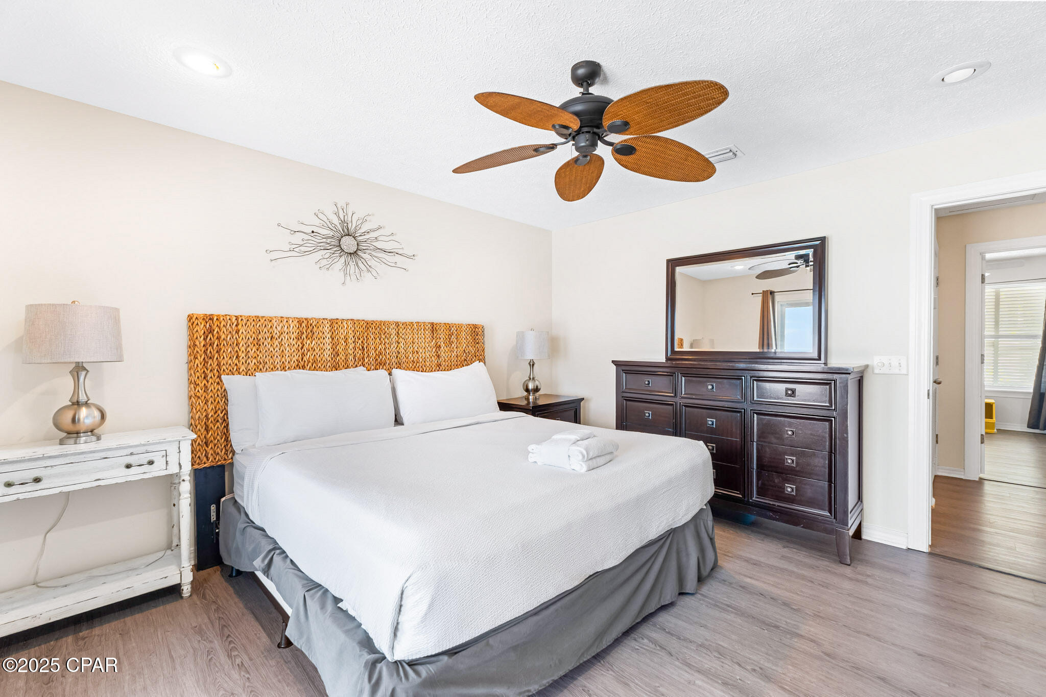17657 Front Beach Road, Unit B Panama City Beach, FL 32413 - Photo 17 of 34 a bedroom with a bed and a chandelier