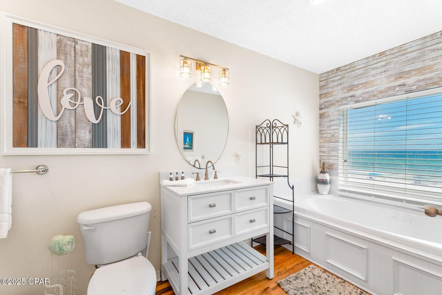 17657 Front Beach Road, Unit B Panama City Beach, FL 32413 - Photo 24 of 34 a bathroom with a toilet a sink and a bathtub