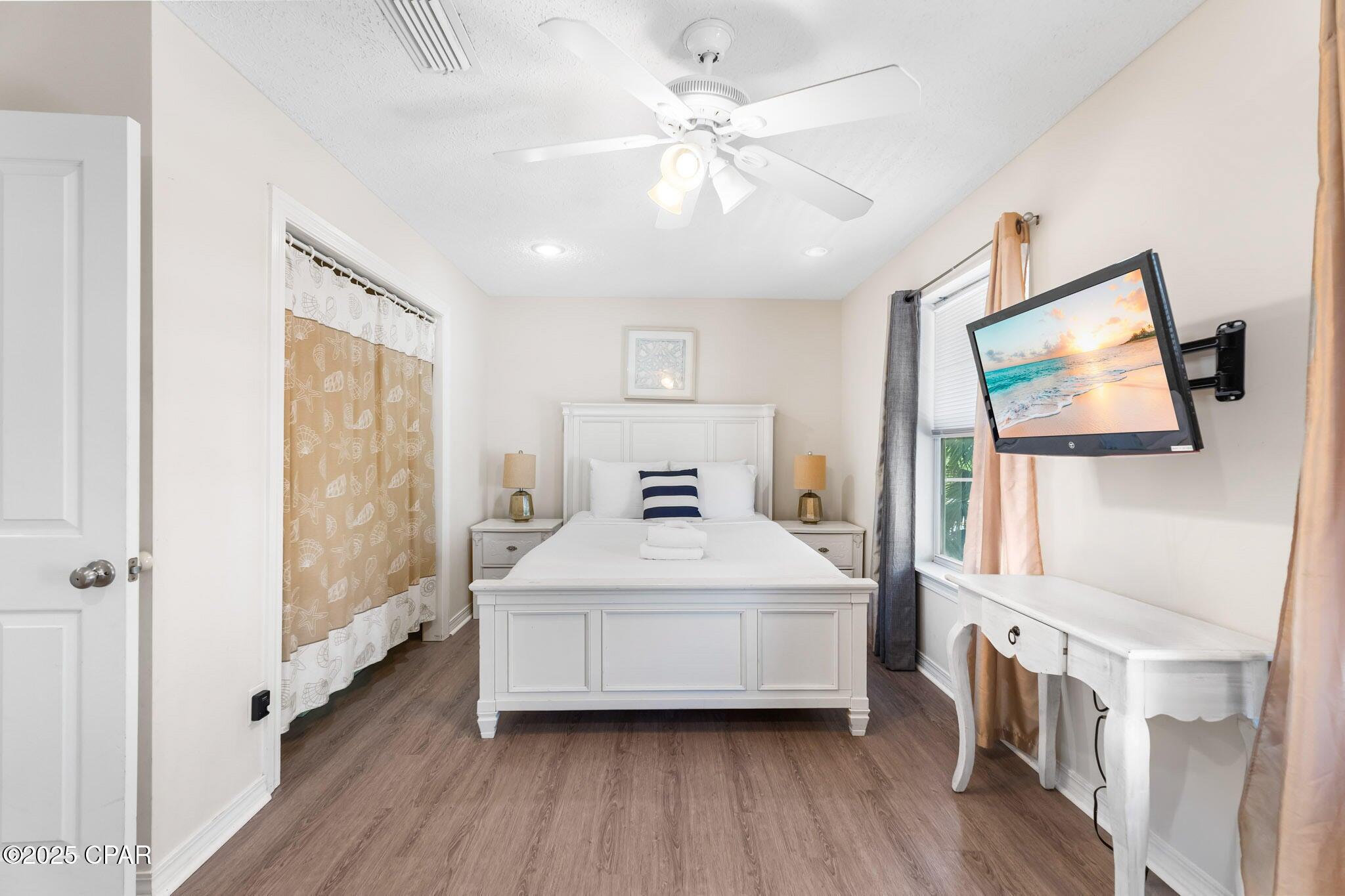 17657 Front Beach Road, Unit B Panama City Beach, FL 32413 - Photo 26 of 34 a spacious bedroom with a bed and a large window