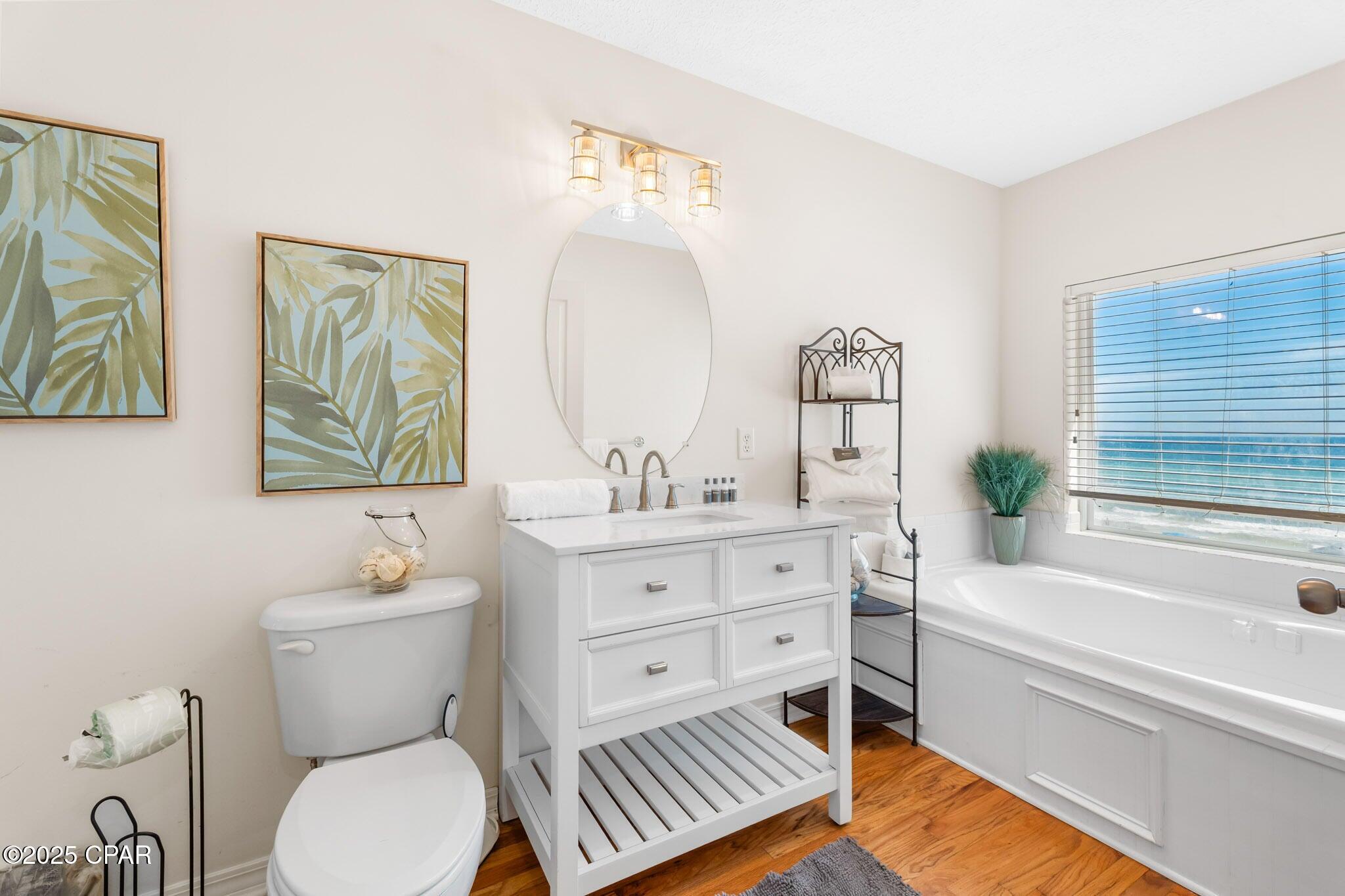 17657 Front Beach Road, Unit B Panama City Beach, FL 32413 - Photo 27 of 34 a bathroom with a sink a toilet and a bathtub