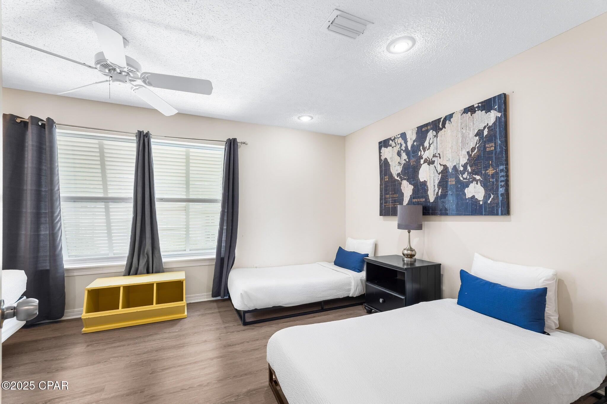 17657 Front Beach Road, Unit B Panama City Beach, FL 32413 - Photo 29 of 34 a bedroom with two beds and a large window