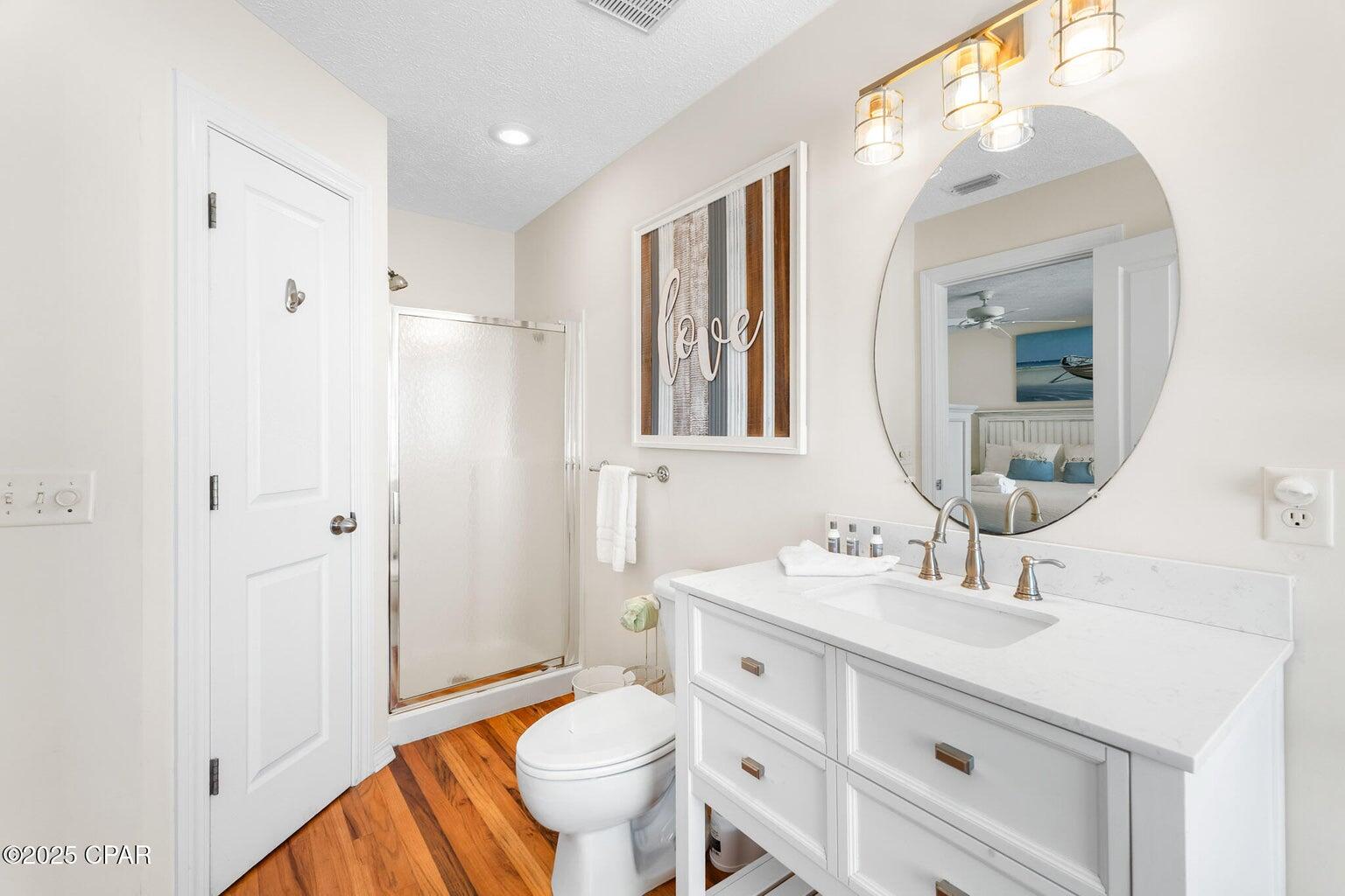 17657 Front Beach Road, Unit B Panama City Beach, FL 32413 - Photo 31 of 34 a bathroom with a sink a toilet and a mirror