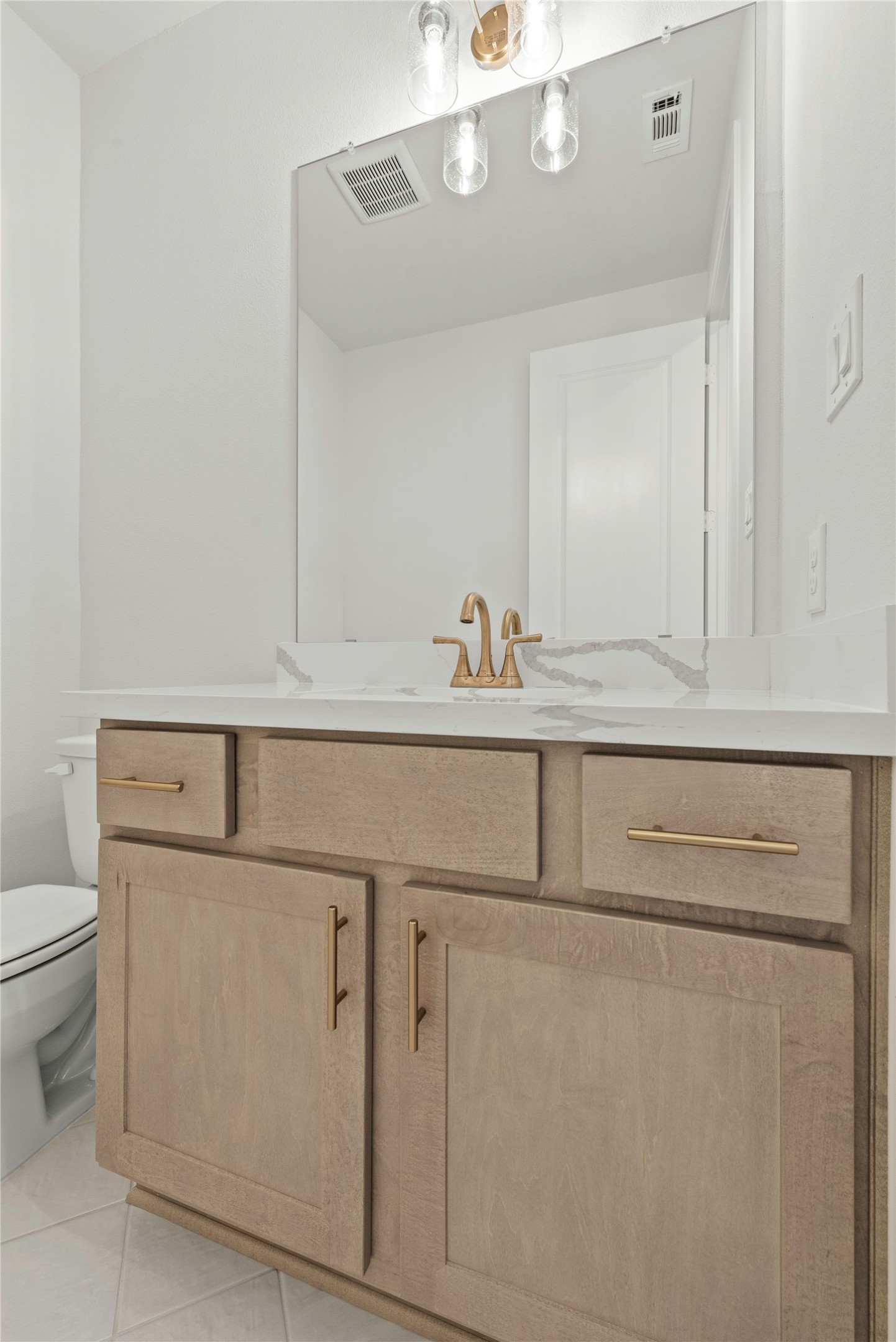 5615 Sandcastle Rdg Drive Katy, TX 77493 - Photo 13 of 27 a bathroom with a sink a toilet and a mirror