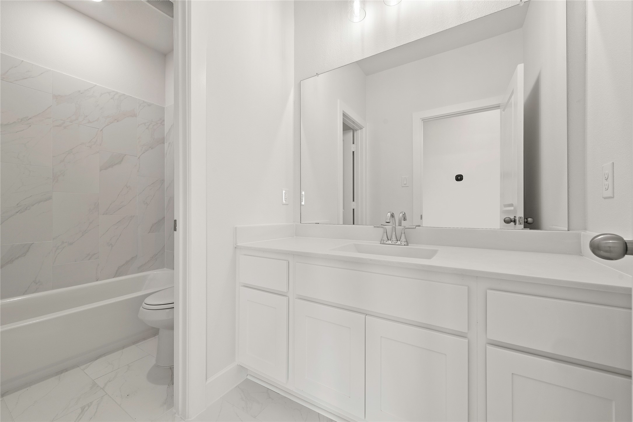 5615 Sandcastle Rdg Drive Katy, TX 77493 - Photo 18 of 27 a bathroom with a sink and a mirror