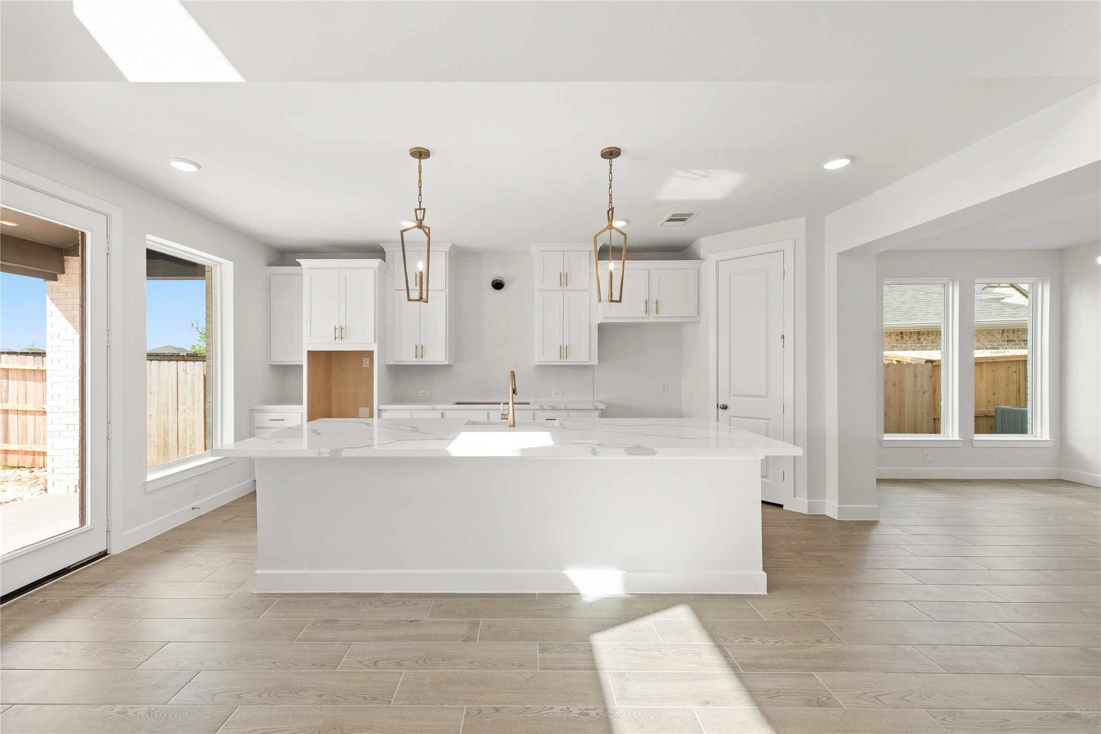 5615 Sandcastle Rdg Drive Katy, TX 77493 - Photo 5 of 27 a large kitchen with kitchen island a stove a sink a center island and windows