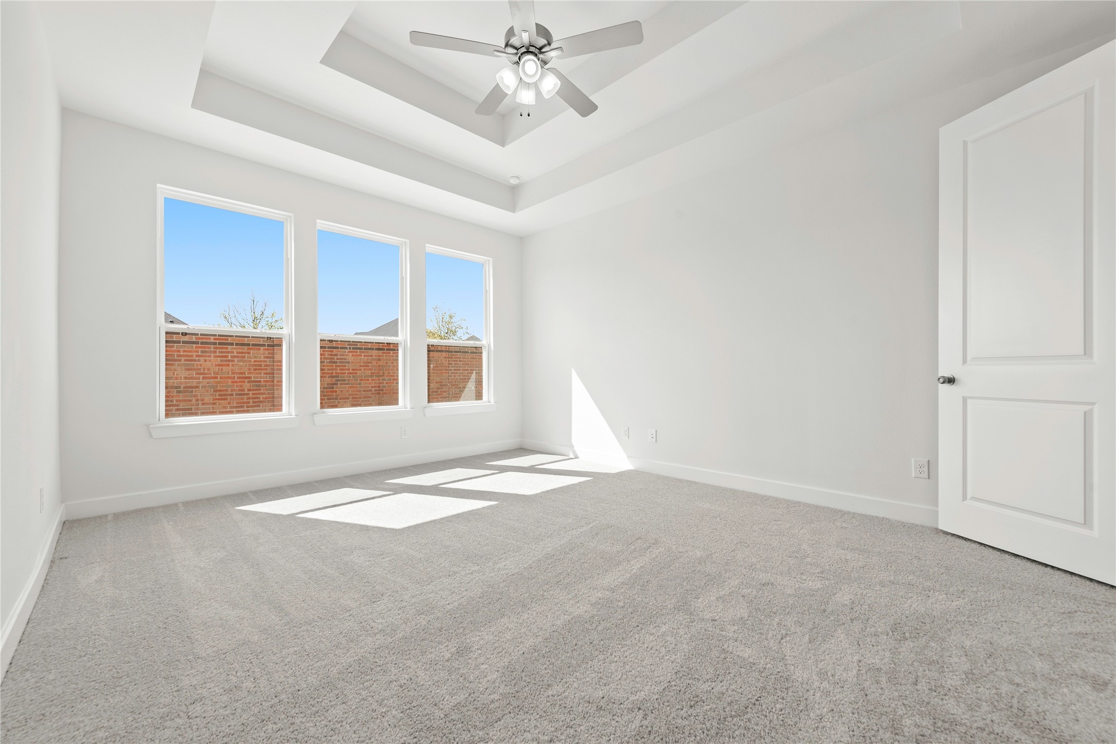 5615 Sandcastle Rdg Drive Katy, TX 77493 - Photo 9 of 27 an empty room with chandelier fan and windows
