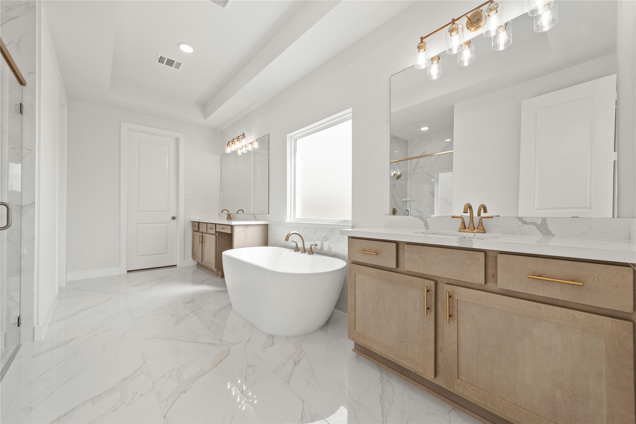 5615 Sandcastle Rdg Drive Katy, TX 77493 - Photo 10 of 27 a bathroom with a double vanity sink mirror and bathtub