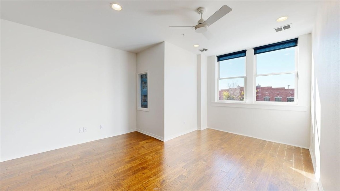 206 North Main Street, Unit 123 Bryan, TX 77803 - Photo 4 of 19 a view of empty room with wooden floor and fan