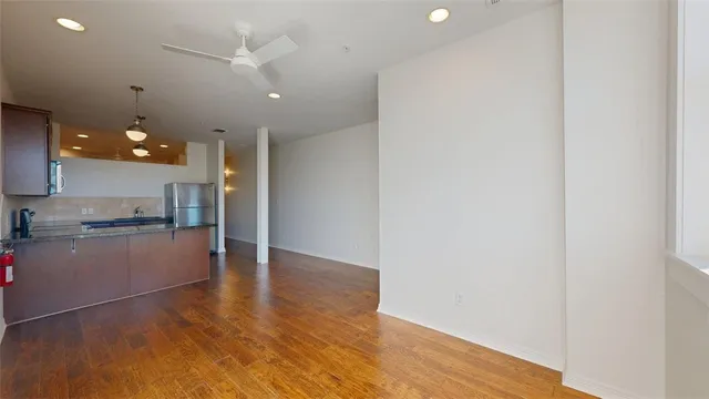 a view of a kitchen with a sink and wooden floor