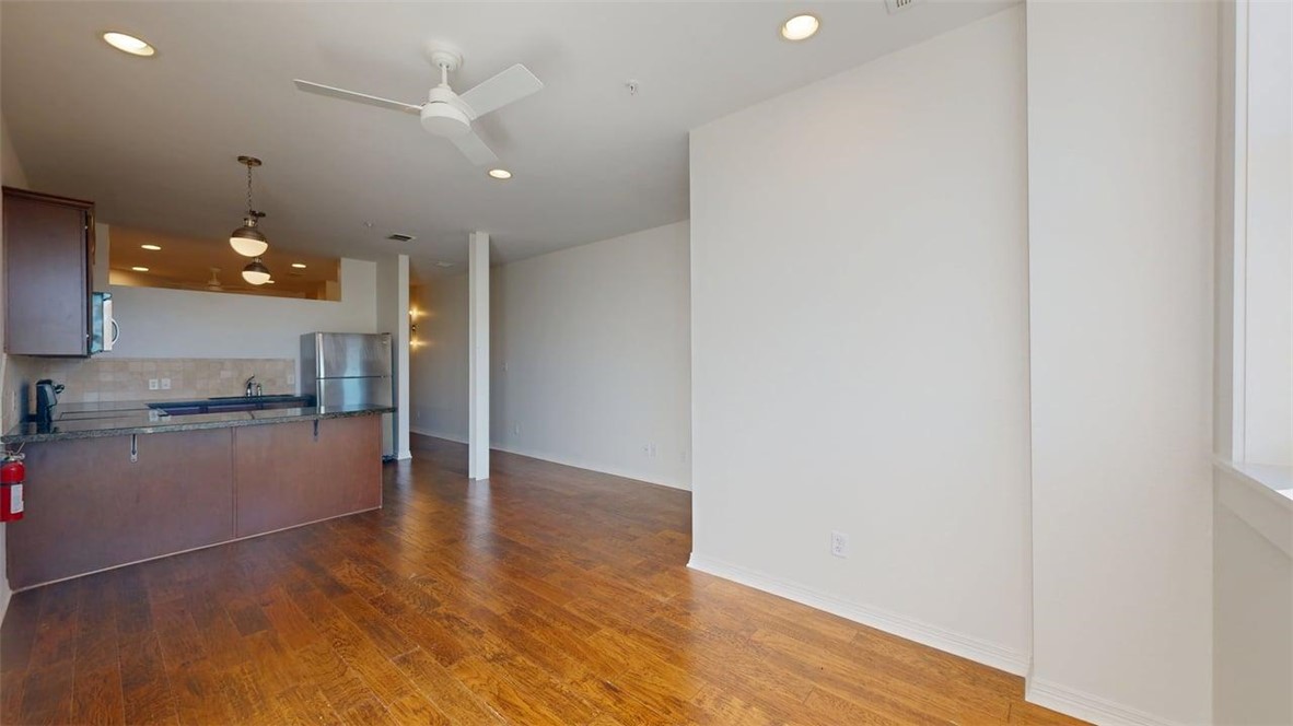 206 North Main Street, Unit 123 Bryan, TX 77803 - Photo 5 of 19 a view of a kitchen with a sink and wooden floor