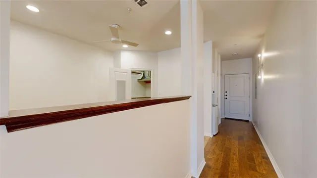 a view of a hallway with wooden floor